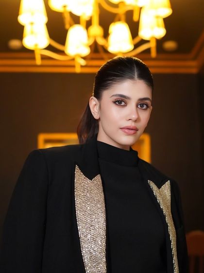 The client looks incredibly chic and powerful with her snatched ponytail. It's the perfect hairstyle to complement her modern, edgy outfit.