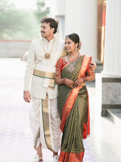 A candid shot of the couple walking together, sharing a smile after their wedding ceremony.