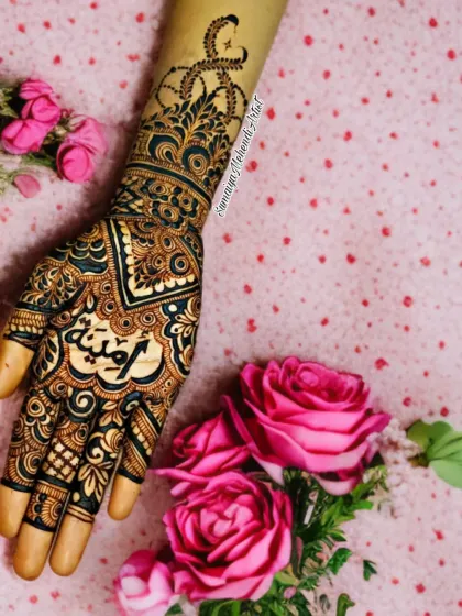 A sweet and personal design with the name 'Amina' on the palm. I love how the name is the centerpiece of this elegant party henna.