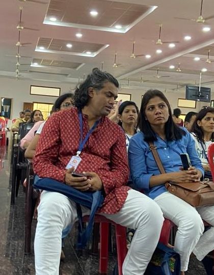 Our team members listening intently during a lecture at the International Yoga Conference.