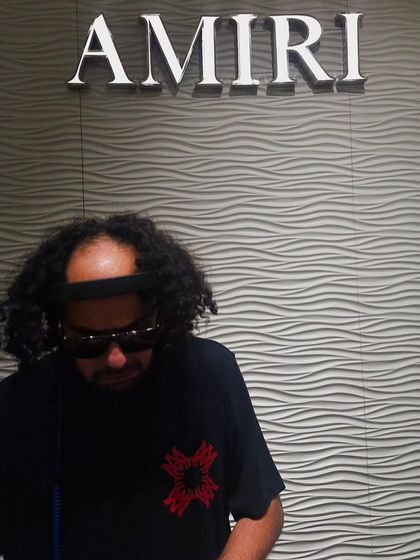 A moody shot of me in front of the Amiri logo. I am experienced in working with luxury brands to provide a soundtrack that matches their high-end aesthetic.