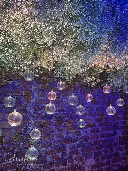 A beautiful installation of baby's breath hanging like a cloud, with glass baubles that catch the light. This created a dreamy, ethereal effect against the rustic brick wall.