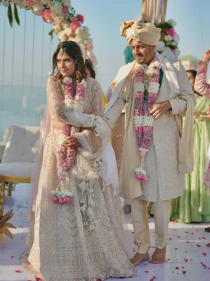 The 'saat phere' or seven steps, a crucial part of the Hindu wedding ritual. We capture the movement and significance of this tradition against a stunning floral mandap.