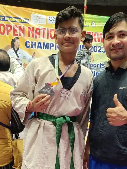 A student proudly shows his silver medal after a tough competition at the national level.