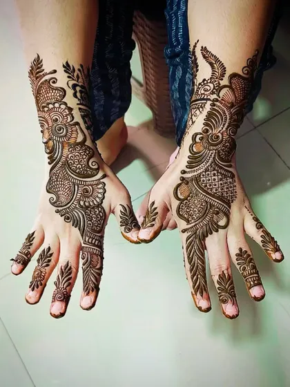An intricate Arabic fusion design for the back of the hands, combining leafy vines with detailed geometric fills.