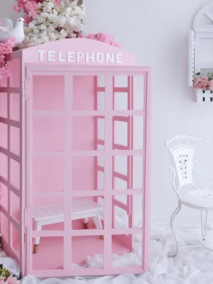 A fairytale waiting to happen. This is our popular pink telephone booth prop, surrounded by beautiful cherry blossoms. It’s a versatile setup that’s perfect for creating magical and whimsical portraits for your little one.