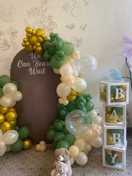 A closer look at the teddy bear themed baby shower decor, with a custom backdrop and "BABY" blocks.
