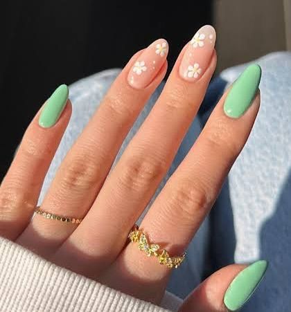 A fresh and pretty nail design for summer. This set features a lovely mint green polish and accent nails with delicate, hand-painted white daisies.