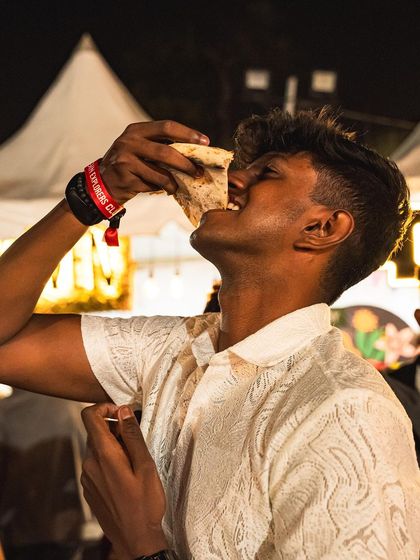 Taking a big bite of the crust. The puffy, charred edge of our Neapolitan pizza is just as delicious as the rest of the slice.