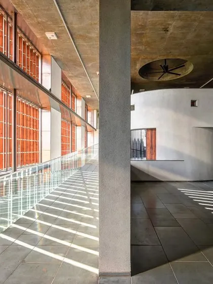 The play of light is a fundamental material in our work. Within the JSW School of Public Policy at IIM Ahmedabad, sunlight filters through terracotta screens, casting rhythmic patterns of light and shadow that animate the circulation spaces and connect the interior to the time of day.