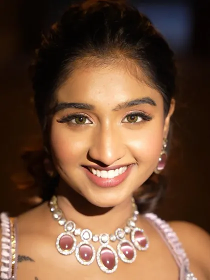A bright, happy smile says it all. The makeup is designed to enhance her natural beauty and make her feel amazing.