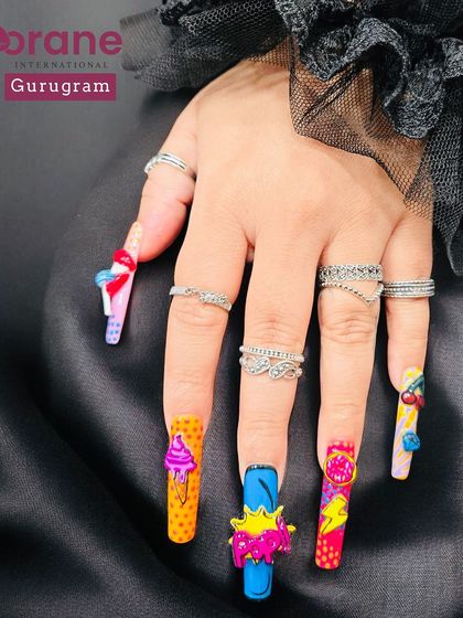 Another view of the Pop Art nails, highlighting the bright colors and whimsical designs. I encourage my students to let their imagination run wild.
