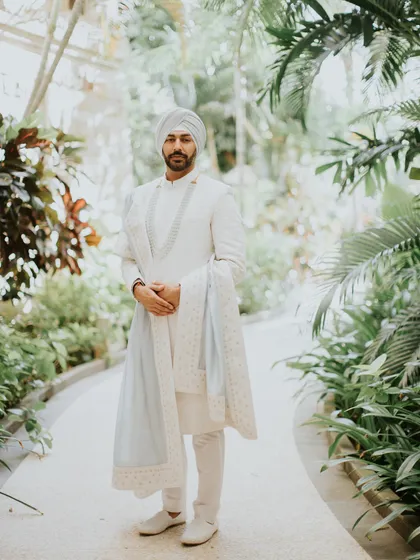 The groom, Manish, looking sharp and serene in his custom ice blue sherwani from Anita Dongre. We went through 15 color swatches to find this perfect shade for his Bali beach wedding.