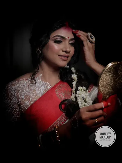 Embracing the goddess within for Durga Puja. This look features a traditional red and white saree, with a dramatic and artistic feel.