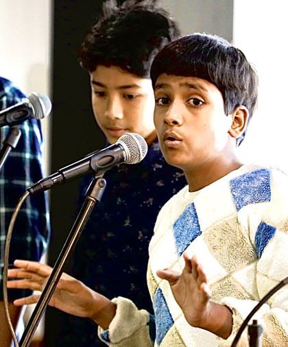 A close-up of one of our young Gully Choir singers, completely focused during a performance. We aim to give every child the confidence to stand before an audience and make their voice heard.