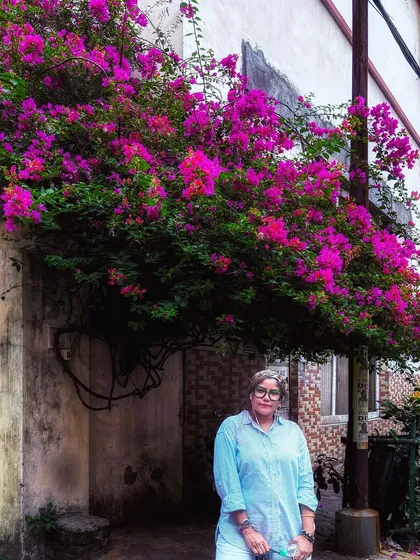 The same casual outfit pictured under a stunning bougainvillea tree, blending fashion with natural beauty.