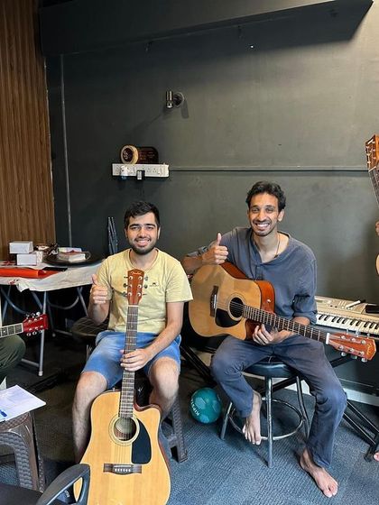 Thumbs up for a great group guitar session. Learning with friends is a fantastic way to stay motivated and have fun while mastering a new instrument.