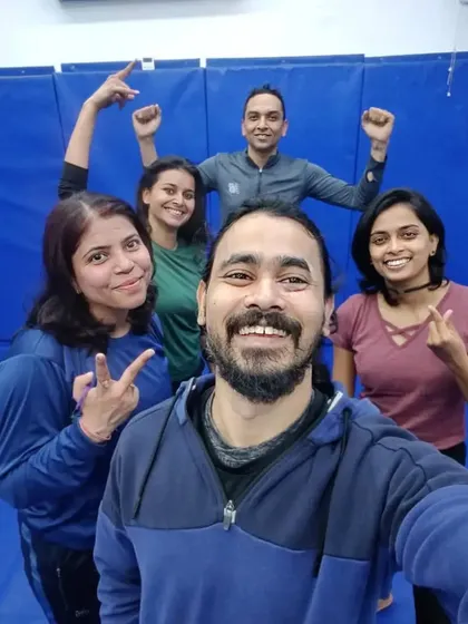 Flexing and smiling after a great No-Gi workout. We build both physical and mental strength.