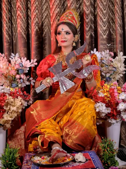 A powerful seated pose with the trishul, capturing the strength and grace of the goddess.