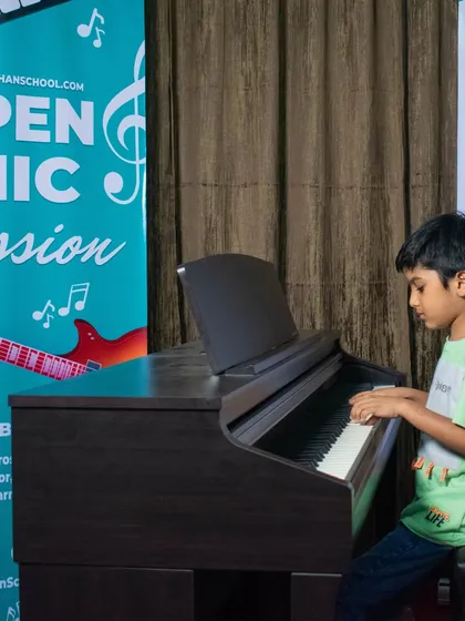 A very young student at the piano, showing that it's never too early to start learning music.