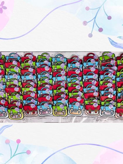 A large batch of "Favor Bag Hampers," which are shaped like little school bags and filled with creative goodies.