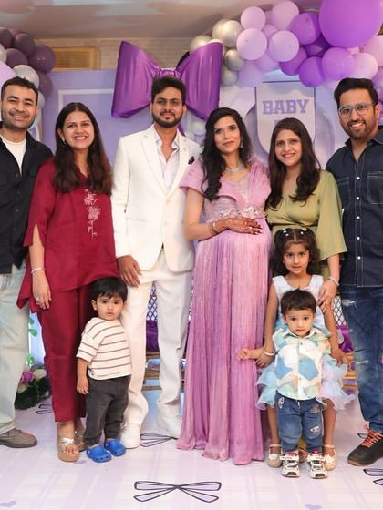 A beautiful family portrait taken at the bow-themed baby shower. The decor provides a perfect backdrop for capturing memories with loved ones.