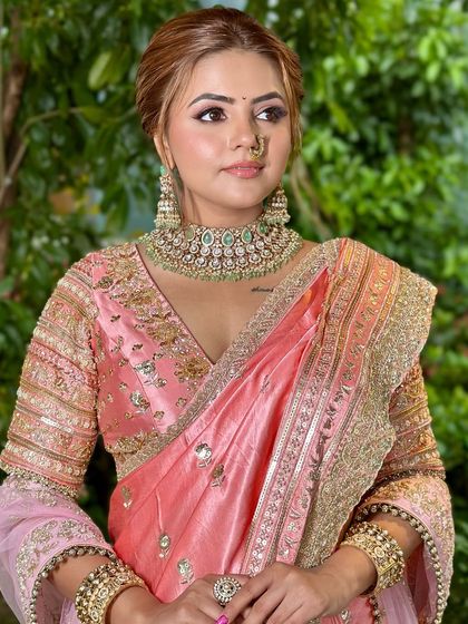 This pose highlights the beautiful embroidery on the blouse and the way the soft makeup complements the entire ensemble without competing with it.