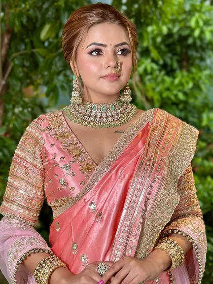 This pose highlights the beautiful embroidery on the blouse and the way the soft makeup complements the entire ensemble without competing with it.