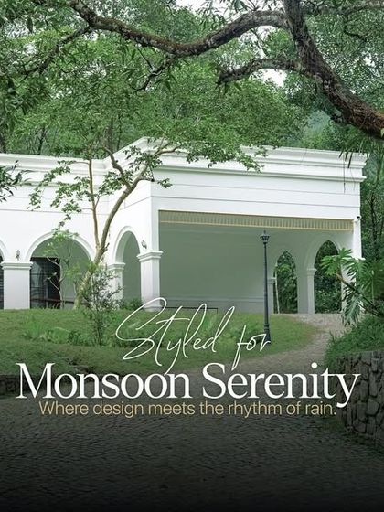 The exterior of this beautiful villa, designed for monsoon serenity. The clean white architecture with arched entryways creates a timeless and welcoming first impression.