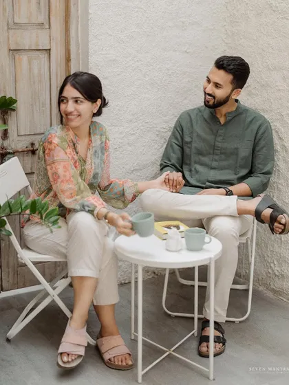 Holding hands across the table. This photo captures the easy, comfortable connection of a couple who are best friends as well as partners.