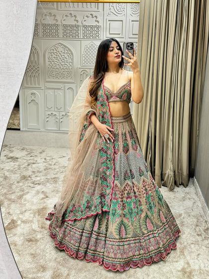 A mirror selfie showcasing the beautiful flare and unique color palette of our 'Unicorn Lehenga'. It's a perfect statement piece for any modern bride or bridesmaid.