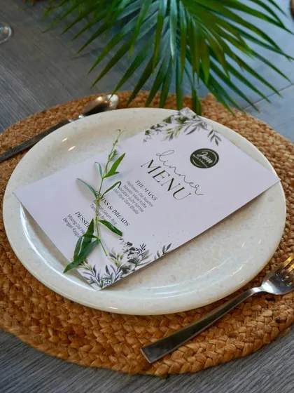 A personalized touch for your guests. We can create custom menu cards that match your event's theme, like this one from an elegant dinner party.