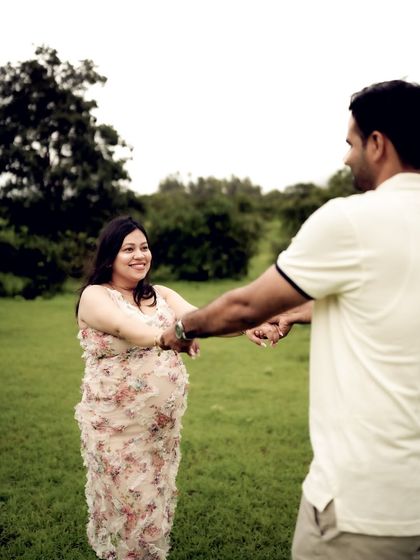 A sweet photo of the couple holding hands, about to dance in a field. The focus is on their connection and the joyful anticipation in their eyes.