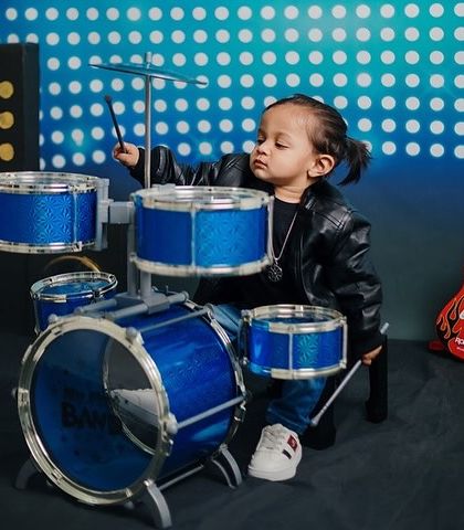 Drumroll please! A little rockstar in a leather jacket is ready for his first drum solo.