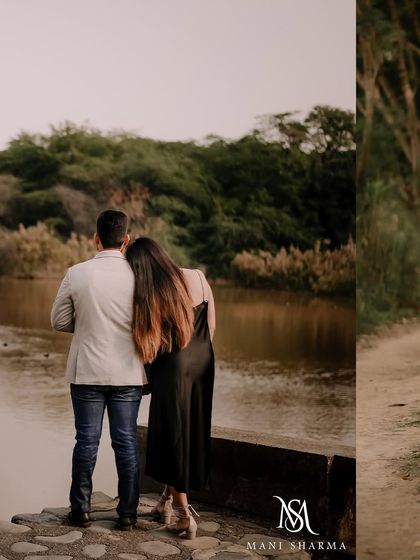 A quiet, reflective moment of the couple looking out over the water during their pre-wedding shoot. This photo captures a sense of peace and togetherness.