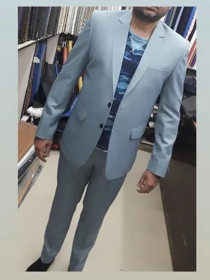 This light blue two piece suit offers a fresh and modern take on formal wear. It’s a versatile piece that can be styled formally with a shirt or casually with a t-shirt.