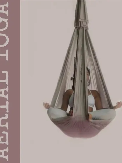 Aerial yoga allows you to explore poses in a new way. Here, a client is in a meditative state inside the silk hammock, which provides gentle support and allows for deep relaxation.