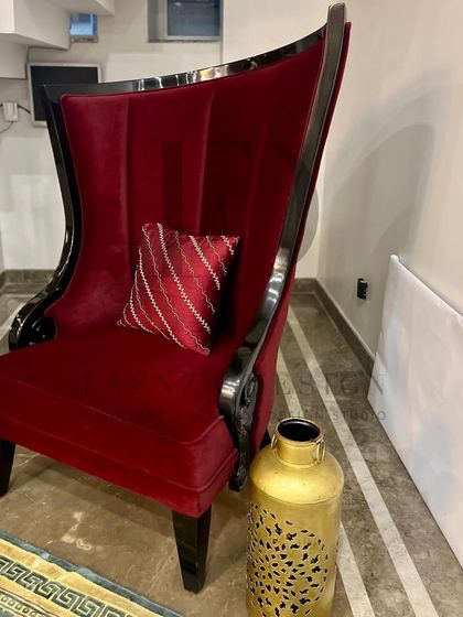 A dramatic, high-back 'throne' chair in deep red velvet with a glossy black lacquered wood frame. This is a true showstopper piece, designed to be the focal point of any room.