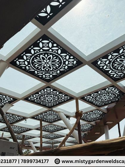 The stunning pattern of the CNC panels under the glass roof is clearly visible in this shot. This combination of materials creates a truly unique and luxurious outdoor ceiling.