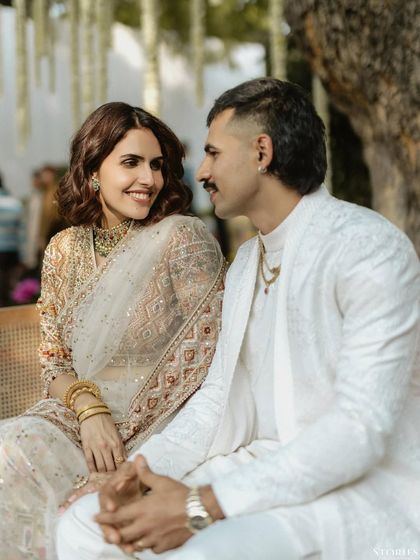 A close, intimate moment between the couple, their relaxed expressions showing the comfort and ease they share.