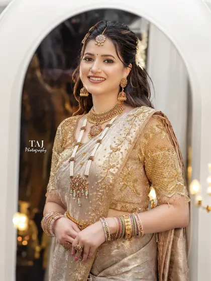A radiant bride in a beautiful golden saree. This portrait captures her happy smile and the traditional elegance of her South Indian bridal look.