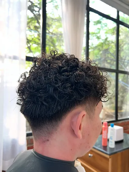 A different view of the men's fade perm, showing the clean V-shape taper at the back. This detail ensures the haircut looks great from every angle and grows out nicely.