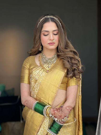 A serene portrait with eyes closed, highlighting the soft, shimmery eyeshadow and the flawless finish of the makeup. It's a look that is peaceful and beautiful.