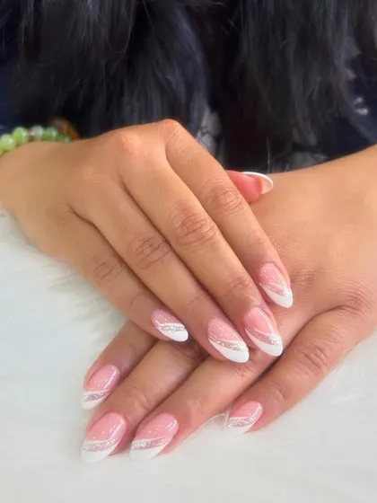 The timeless French manicure, perfected with clean lines and a subtle silver swirl for a touch of flair.
