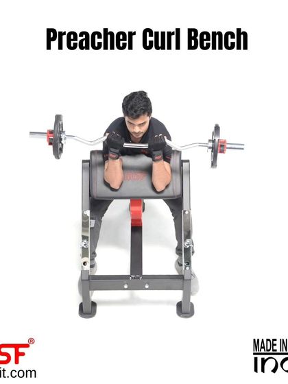 A front view of a user on the Preacher Curl Bench.
