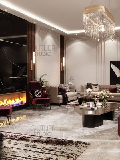 This living room exudes warmth with its modern fireplace and deep red accent chairs. The combination of a black marble feature wall and classic white mouldings creates a timeless and elegant design.