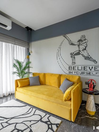 Another look at the boy's room, focusing on the vibrant yellow sofa and the inspiring "Believe in Yourself" wall mural. It's a space designed to be both comfortable for lounging and motivating for a young athlete.