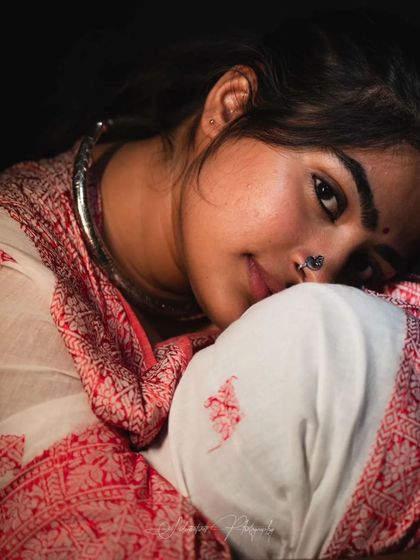 A soft and intimate studio portrait. The makeup is kept very natural to enhance the gentle and personal feel of the photo.