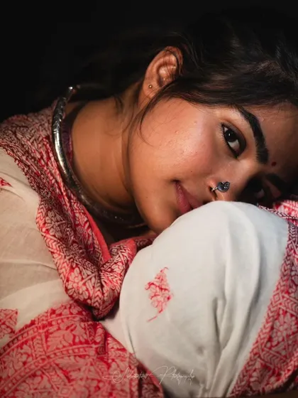 A soft and intimate studio portrait. The makeup is kept very natural to enhance the gentle and personal feel of the photo.