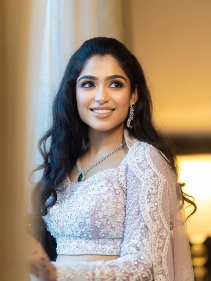 The happy smile of a bride who feels beautiful. This candid shot captures the success of a look that feels both glamorous and authentic.